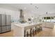 Bright, open kitchen featuring a large island with bar seating, stainless steel appliances, and modern pendant lighting at 1020 W Princeton St, Orlando, FL 32804