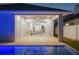 Inviting outdoor patio at twilight, adjacent to a sparkling pool and the main living area visible through sliding glass doors at 1020 W Princeton St, Orlando, FL 32804