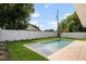 Backyard featuring a modern pool, green grass, privacy fence, and lush landscaping, perfect for outdoor living at 1020 W Princeton St, Orlando, FL 32804