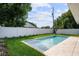 Inviting backyard pool with lush green grass and white privacy fence at 1020 W Princeton St, Orlando, FL 32804