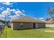 A fenced backyard with a sliding glass door entrance to the home at 1928 Michigan Ct, Kissimmee, FL 34759