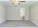 Spacious bedroom with neutral walls, soft carpeting, and an ensuite bathroom at 1928 Michigan Ct, Kissimmee, FL 34759