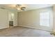 Large bedroom featuring neutral walls, plush carpet, and an ensuite bathroom at 1928 Michigan Ct, Kissimmee, FL 34759