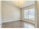 Charming dining room featuring wood floors, a modern chandelier, and natural light at 1928 Michigan Ct, Kissimmee, FL 34759