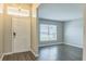 Inviting foyer with white door, transom window and hardwood floors leading to the living area at 1928 Michigan Ct, Kissimmee, FL 34759