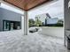 Backyard view of a modern home with outdoor kitchen, fire pit, and well-manicured landscaping at 2522 Lafayette Ave, Winter Park, FL 32789