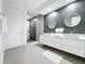 Modern bathroom features a double sink vanity, round mirrors, and walk-in shower at 2522 Lafayette Ave, Winter Park, FL 32789