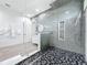 Sleek bathroom featuring a glass shower, modern fixtures, and stylish black and gray tile flooring at 2522 Lafayette Ave, Winter Park, FL 32789