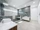 Modern bathroom featuring dual sinks, marble accents, a glass-enclosed shower, and a unique tile design at 2522 Lafayette Ave, Winter Park, FL 32789