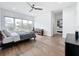 Spacious bedroom featuring a ceiling fan, large window, and a view into the attached bathroom at 2522 Lafayette Ave, Winter Park, FL 32789