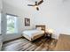 Cozy bedroom with hardwood floors, a ceiling fan, and a bright window offering natural light at 2522 Lafayette Ave, Winter Park, FL 32789