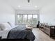 Bright bedroom with large window, hardwood floors, and minimalist furniture at 2522 Lafayette Ave, Winter Park, FL 32789
