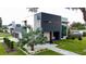 Modern home featuring a striking dark and white exterior, surrounded by vibrant landscaping and green lawns at 2522 Lafayette Ave, Winter Park, FL 32789