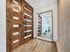 Inviting home entrance featuring a modern wood door, stylish mirror, and elegant wood flooring at 2522 Lafayette Ave, Winter Park, FL 32789