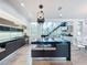 Modern kitchen with sleek black cabinetry, unique lighting, and an eat-in island at 2522 Lafayette Ave, Winter Park, FL 32789