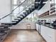 Well lit Living area featuring a staircase, hardwood floors, and bar area with stainless steel appliances at 2522 Lafayette Ave, Winter Park, FL 32789