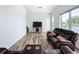 Cozy living room with hardwood floors, theater seating, a television, and plenty of natural light at 2522 Lafayette Ave, Winter Park, FL 32789