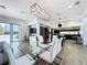 Modern living area with glass dining table, sleek kitchen, and bright, open layout with outdoor access at 2522 Lafayette Ave, Winter Park, FL 32789