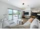 Bright living room with modern sofas, a TV, and large sliding glass doors leading to the outdoor patio at 2522 Lafayette Ave, Winter Park, FL 32789