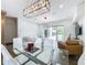 Bright living room featuring modern lighting, glass table, and sliding glass doors to the outdoor area at 2522 Lafayette Ave, Winter Park, FL 32789