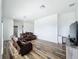 Spacious living room with wood floors, theater seating, and a dedicated desk area with a marble countertop at 2522 Lafayette Ave, Winter Park, FL 32789