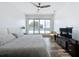 Modern bedroom featuring a large sliding door to a private balcony, wood flooring, and a ceiling fan at 2522 Lafayette Ave, Winter Park, FL 32789