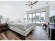 Well-lit bedroom boasts floor-to-ceiling windows to a private balcony, wood floors, and ceiling fan at 2522 Lafayette Ave, Winter Park, FL 32789