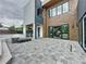 Modern backyard patio featuring a built-in outdoor kitchen, a fire pit, and large sliding glass doors at 2522 Lafayette Ave, Winter Park, FL 32789