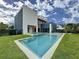 Modern home showcasing a pool, jacuzzi, and expansive green yard, ideal for outdoor living at 2522 Lafayette Ave, Winter Park, FL 32789