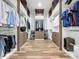 Spacious walk-in closet with custom shelves, drawers, and wooden floors for optimal storage and organization at 2522 Lafayette Ave, Winter Park, FL 32789