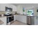 Kitchen with stainless steel appliances and white cabinets at 3503 Fort Mellon Ln, Sanford, FL 32773