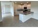 Open kitchen with island, granite countertops, and white cabinets at 3503 Fort Mellon Ln, Sanford, FL 32773