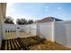 Backyard with a white picket fence and gate, offering a private outdoor space at 176 Blackstone Creek Rd, Groveland, FL 34736