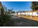 Large backyard area with a metal pergola, concrete pavers, and a well-maintained privacy fence at 176 Blackstone Creek Rd, Groveland, FL 34736