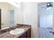 This is a bathroom with wood cabinets, a vanity mirror, and tile floors at 176 Blackstone Creek Rd, Groveland, FL 34736