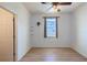 This is a bedroom with wood floors, a ceiling fan, a window, and white walls at 176 Blackstone Creek Rd, Groveland, FL 34736