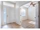 Bright entryway with tile flooring and a view into the adjacent bedroom with a ceiling fan and natural light at 176 Blackstone Creek Rd, Groveland, FL 34736