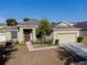 Charming single-story home featuring a well-manicured front yard, neutral tones, and an attached two-car garage at 176 Blackstone Creek Rd, Groveland, FL 34736