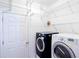 A laundry room with shelving and a washer and dryer at 176 Blackstone Creek Rd, Groveland, FL 34736