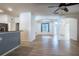 Spacious living room with wood floors and an open concept leading to the kitchen and entryway at 176 Blackstone Creek Rd, Groveland, FL 34736