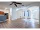 Bright living room with wood floors and an open concept leading to the kitchen and the entryway at 176 Blackstone Creek Rd, Groveland, FL 34736