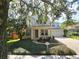 Beautiful home with lush lawn and mature trees creating a peaceful setting at 226 W Tarrington Dr, Deland, FL 32724