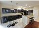 Large kitchen featuring granite countertops, stainless appliances, tile floors, and island seating at 226 W Tarrington Dr, Deland, FL 32724