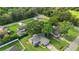 Aerial view of the home in a lush, green neighborhood with mature trees and nearby amenities at 304 Hibiscus St, Chuluota, FL 32766