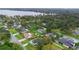 Scenic aerial view of the neighborhood with lush greenery and a lake in the distance at 304 Hibiscus St, Chuluota, FL 32766