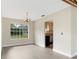 Inviting dining room area with view into the kitchen and large window at 304 Hibiscus St, Chuluota, FL 32766