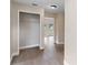 Hallway with hardwood floors and french doors at the end of the hall at 304 Hibiscus St, Chuluota, FL 32766