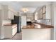 Well-lit kitchen featuring laminate countertops, a black refrigerator, and stainless steel appliances at 304 Hibiscus St, Chuluota, FL 32766