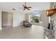 Cozy living room with large windows, fireplace, and hardwood floors at 304 Hibiscus St, Chuluota, FL 32766
