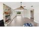 Open living room featuring a stone fireplace and ample natural light at 304 Hibiscus St, Chuluota, FL 32766